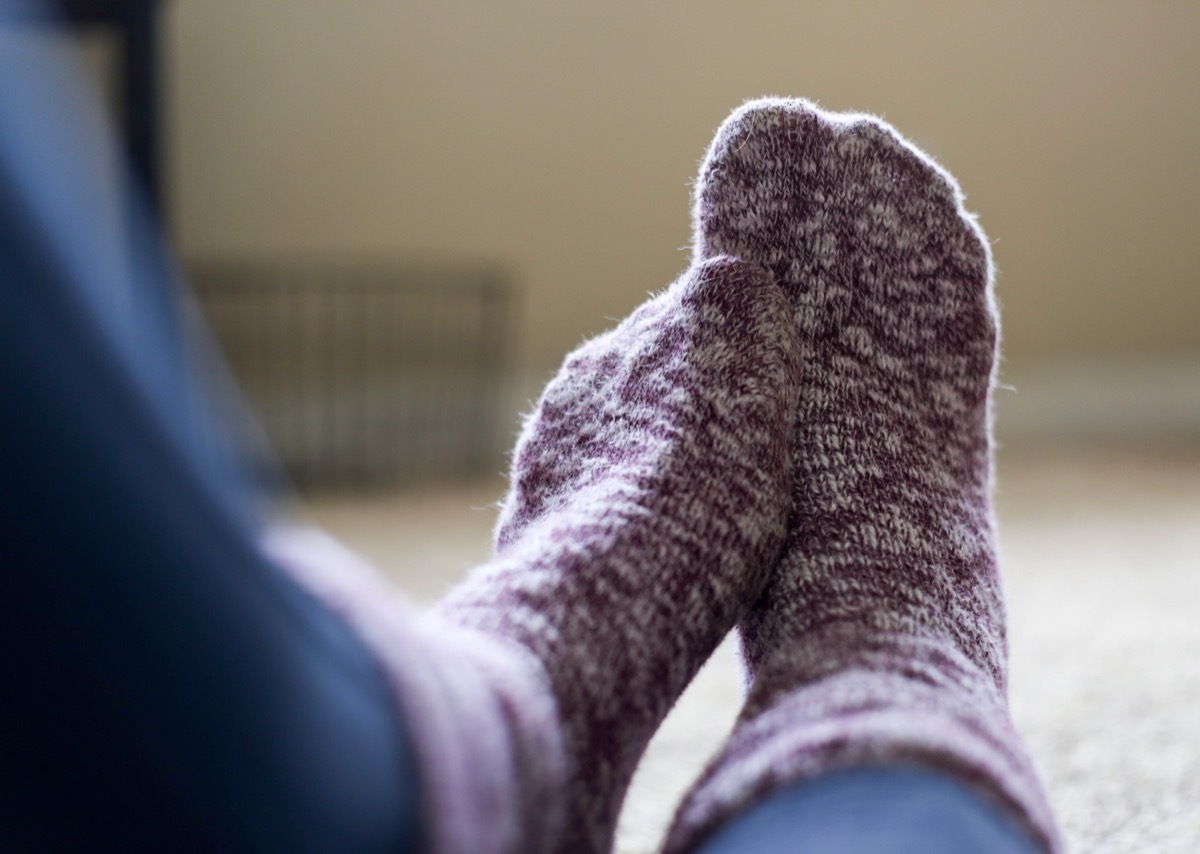 Woman Wearing Fuzzy Socks Aching Feet foot pain