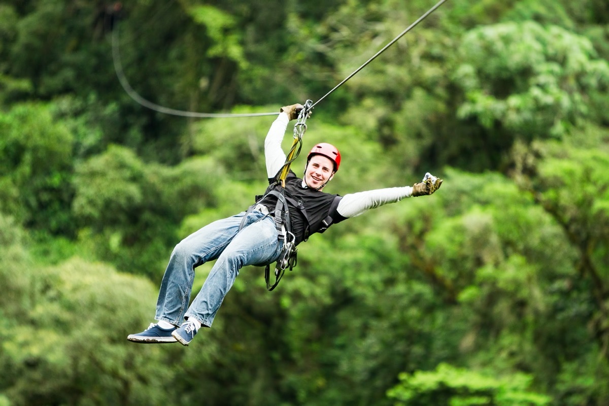 man on a zipline in the daytime