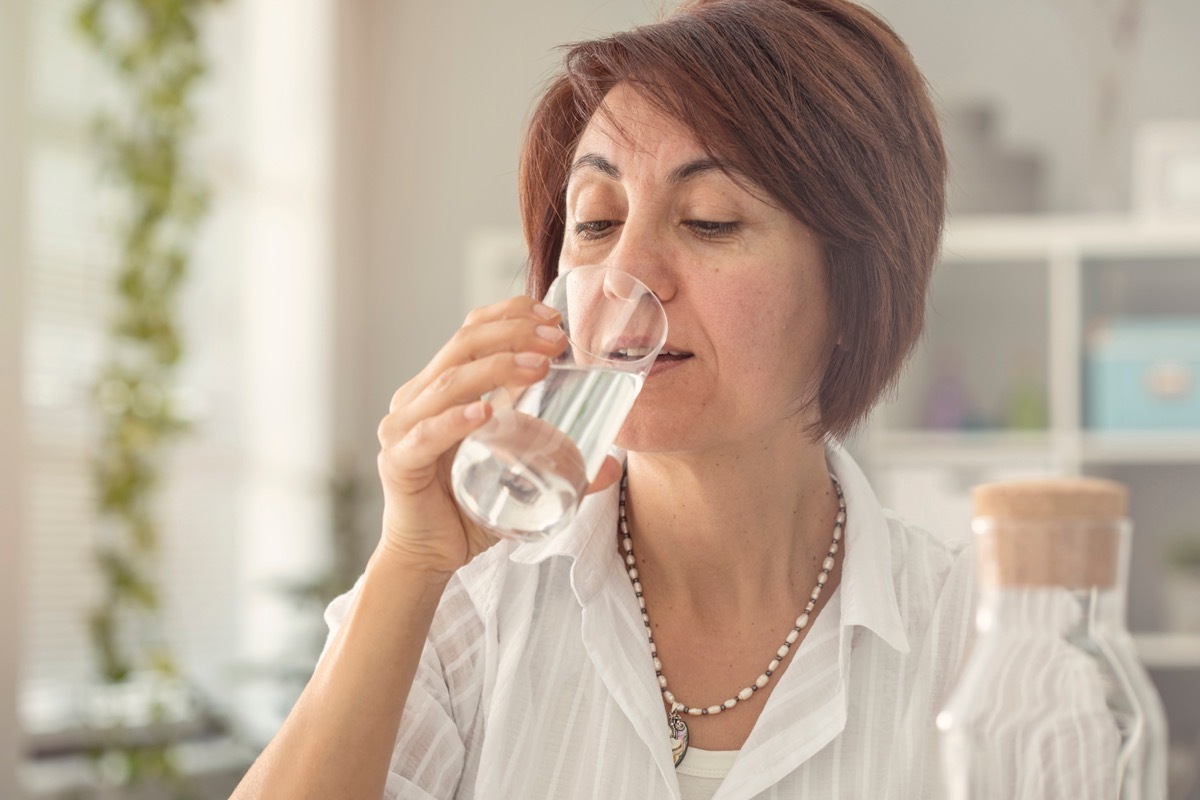 Older woman drinking a glass of water