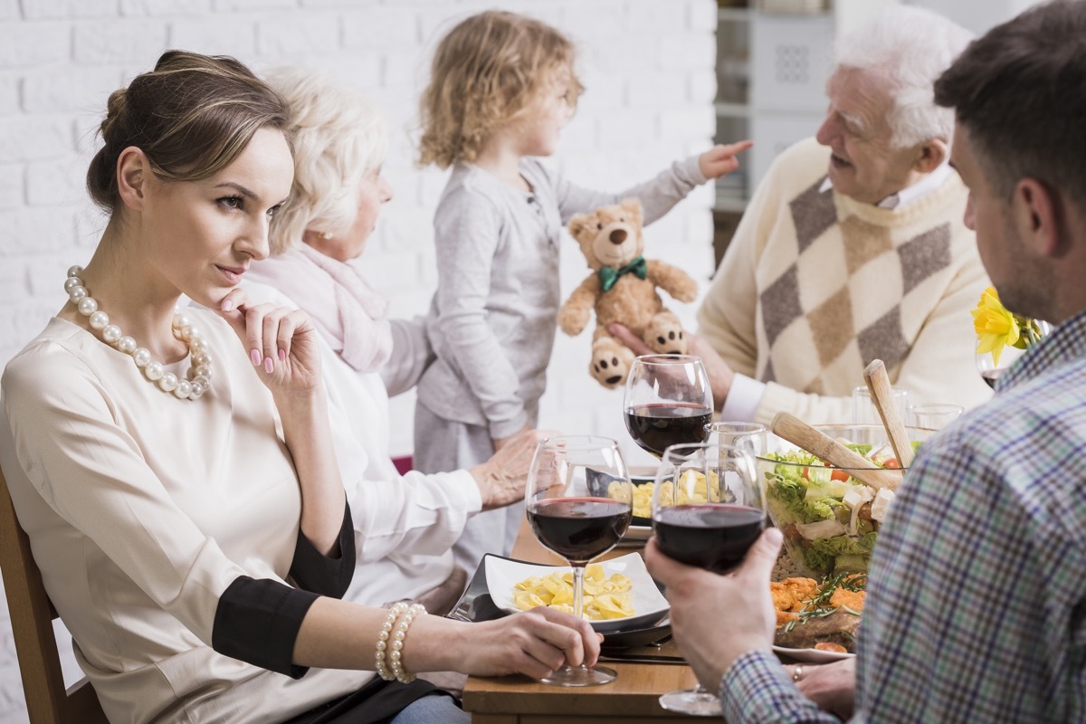Shot of a family dinner with a young couple in the foreground