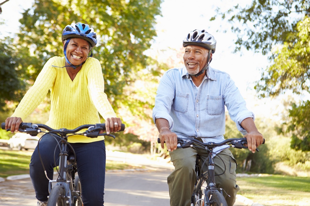 Older couple riding bikes to lower their carbon footprint