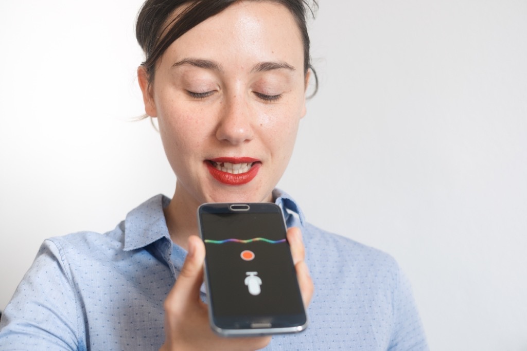 Woman using iPhone Siri 2018 Predictions