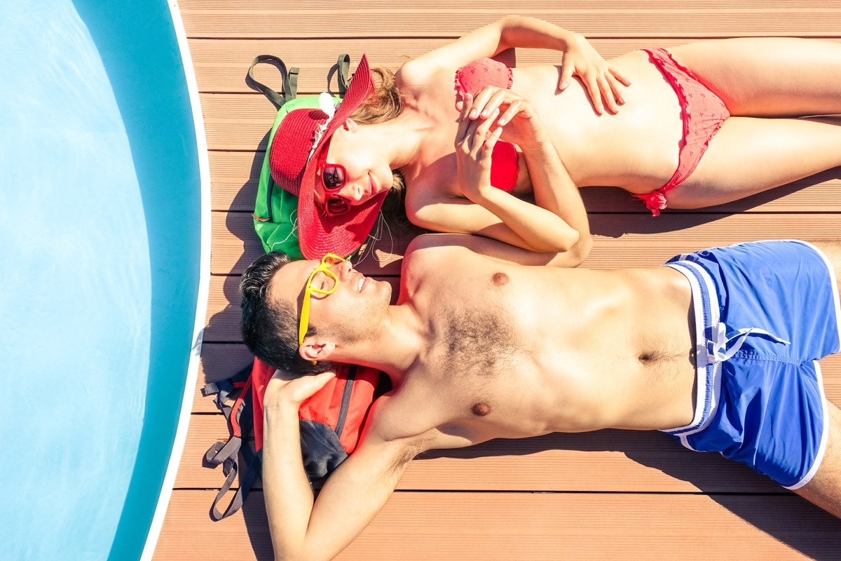 Shutterstock Couple sunbathing on cruise ship deck cruise ship facts