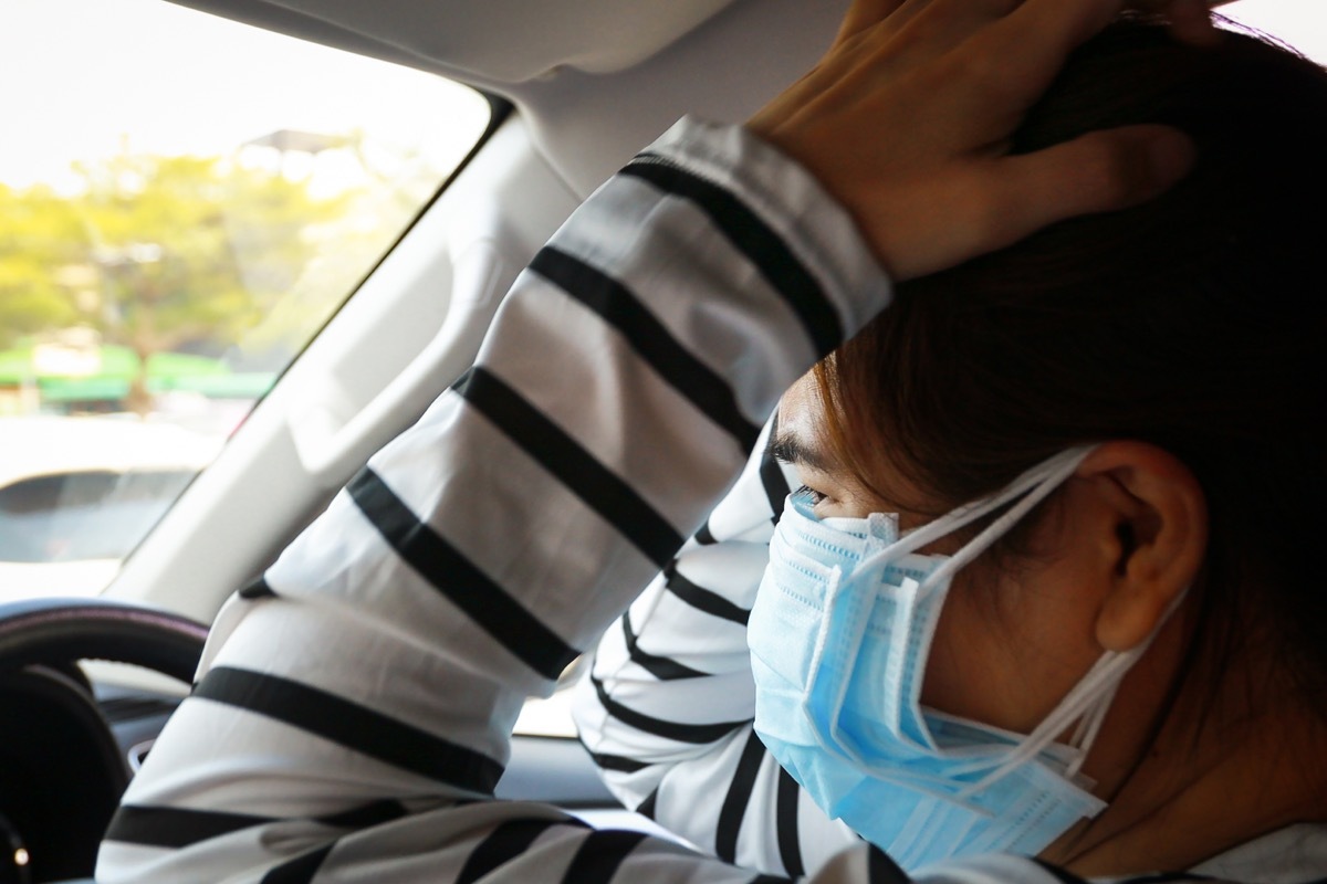 woman wearing too many masks scared