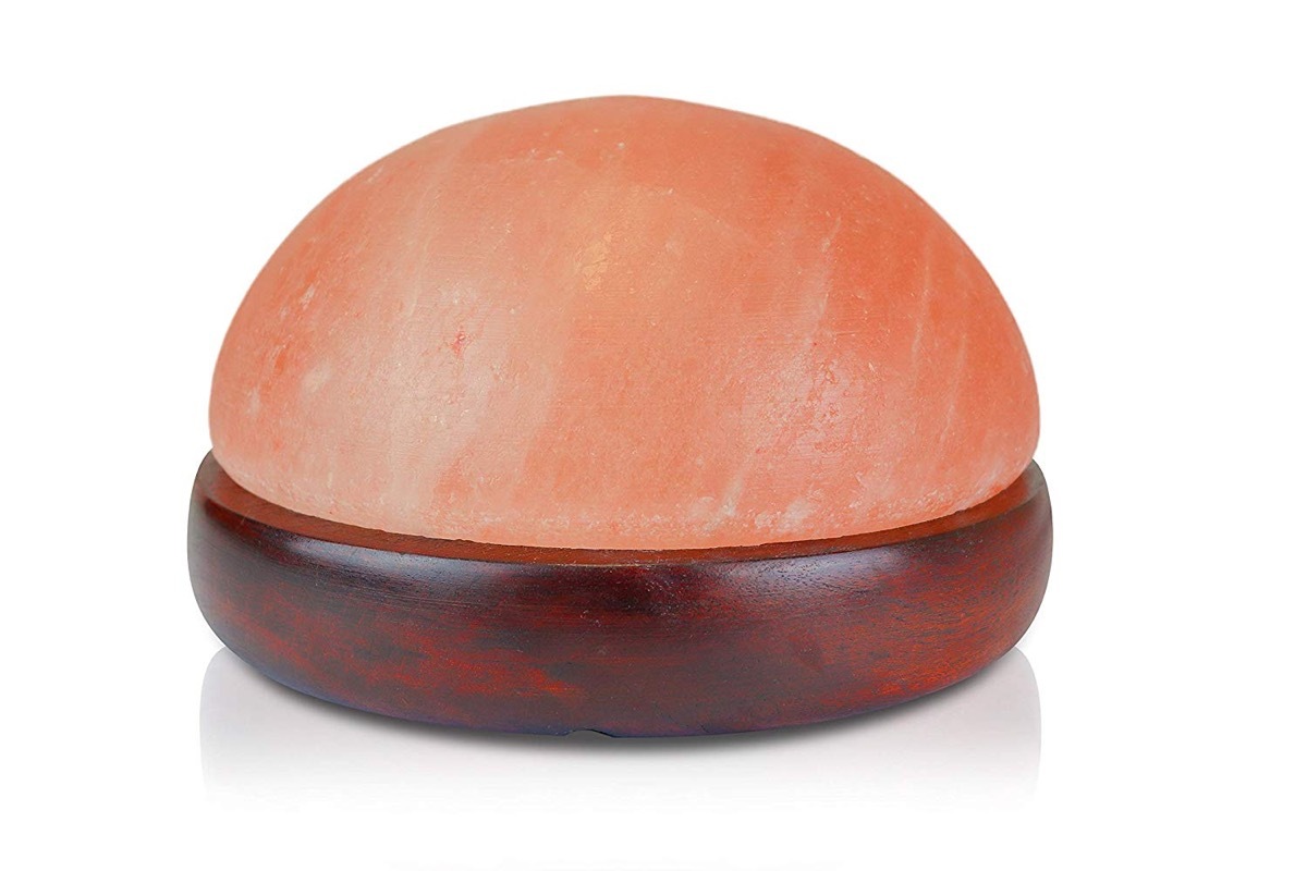 rounded salt lamp on wooden base