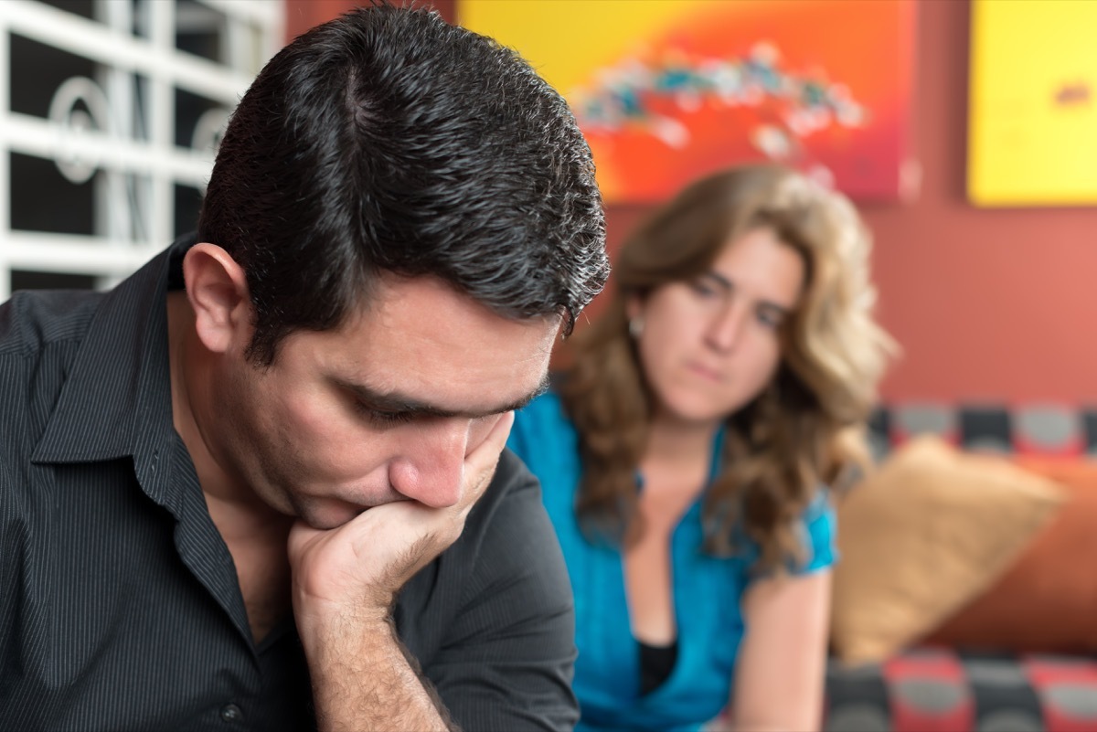 middle aged white couple arguing while sitting down together