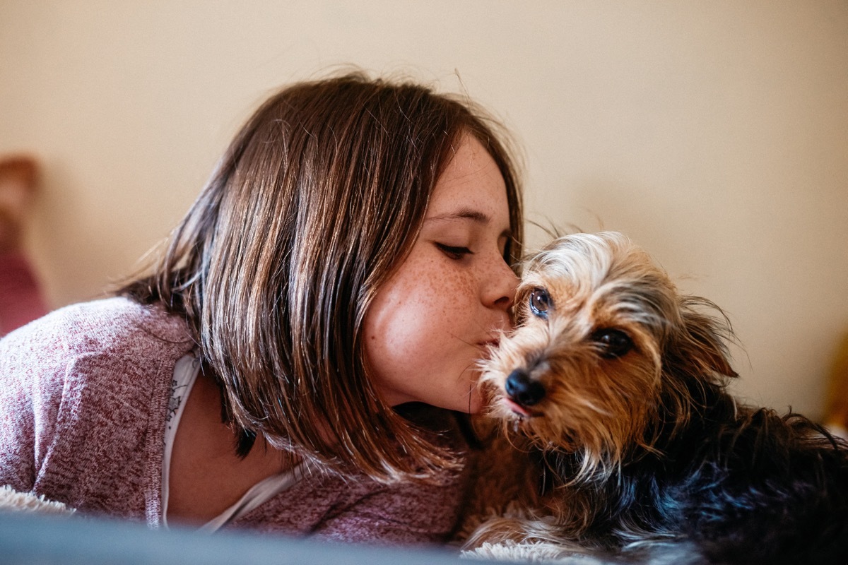 cropped shot of an adorable young girl bonding with her dog