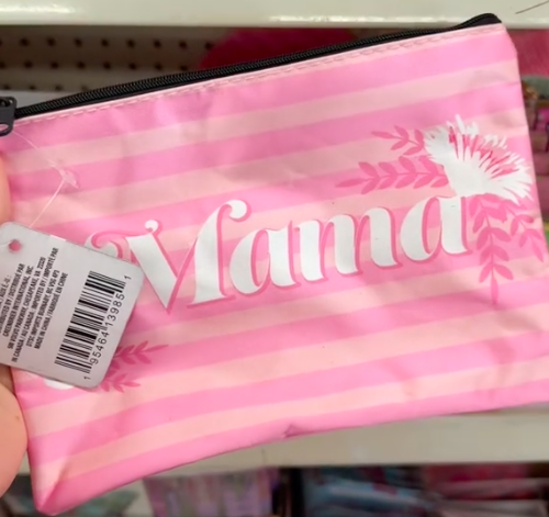 A shopper holds a pink cosmetic bag with the word