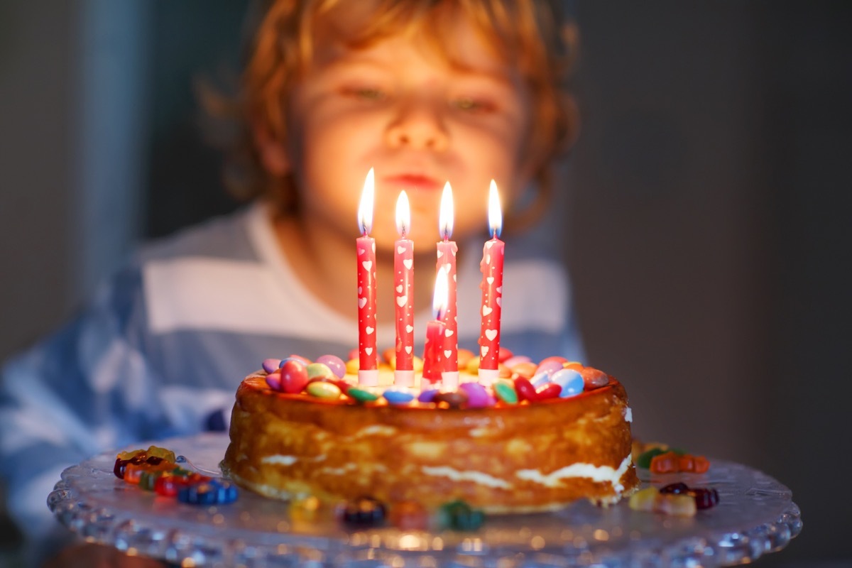 Little boy blowing out birthday candles