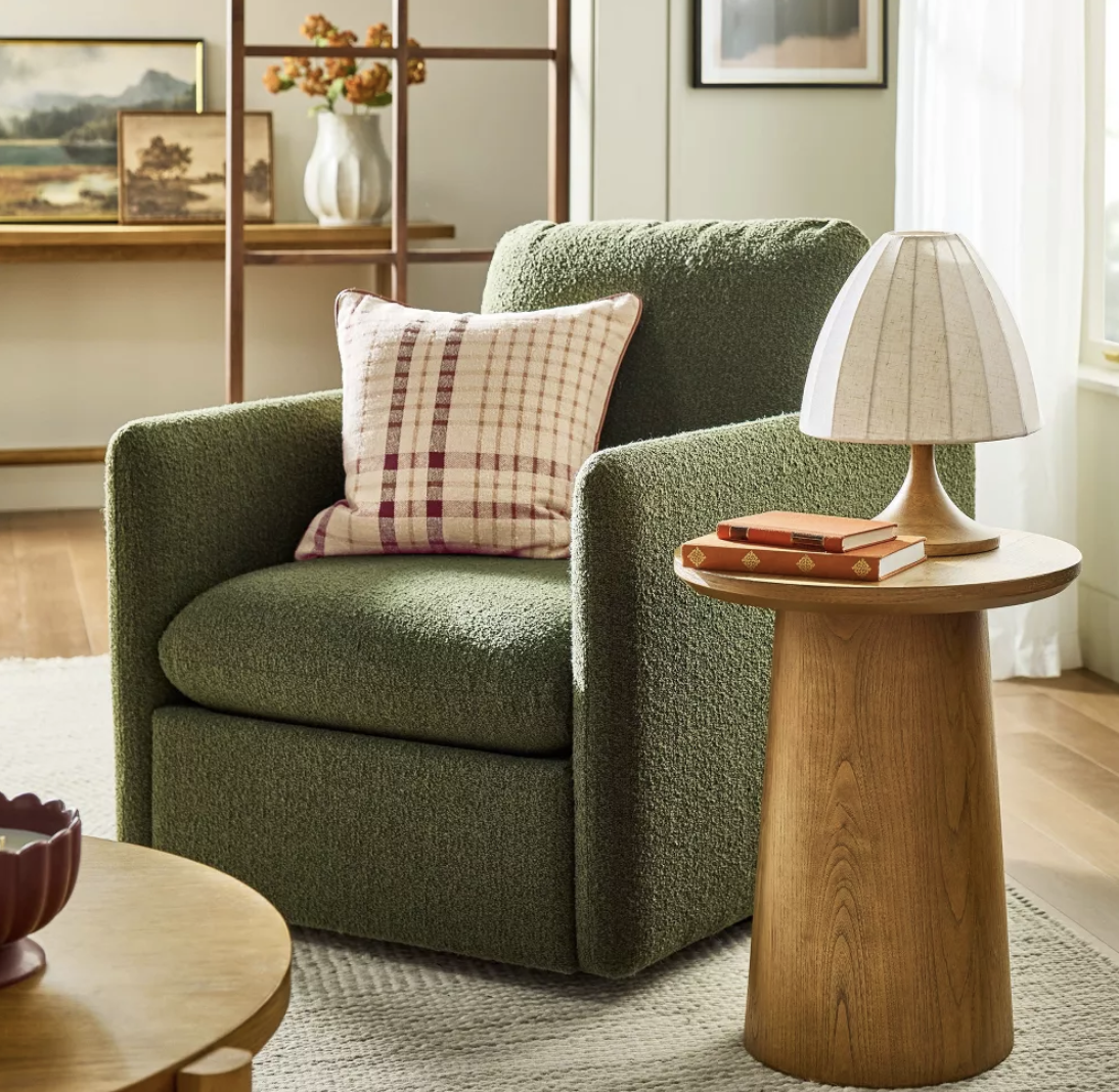 plaid throw pillow on a green accent chair