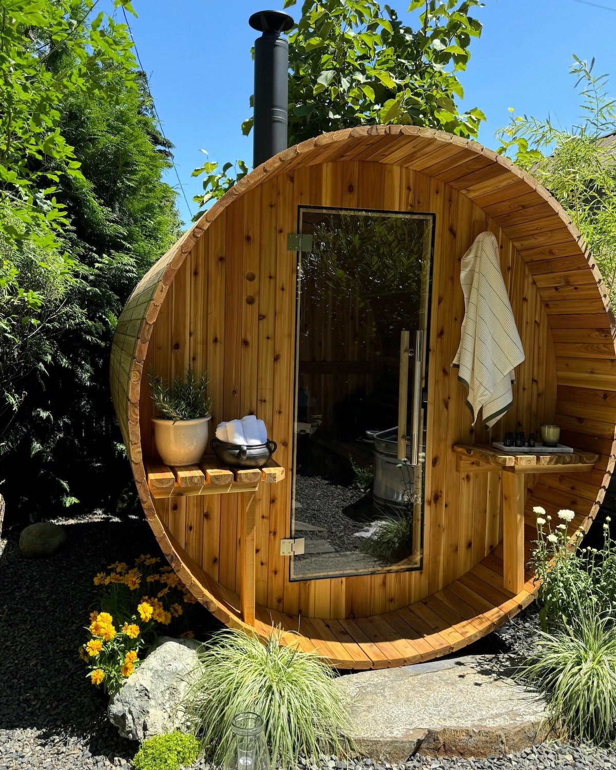 a wooden barrel sauna out in the wilderness
