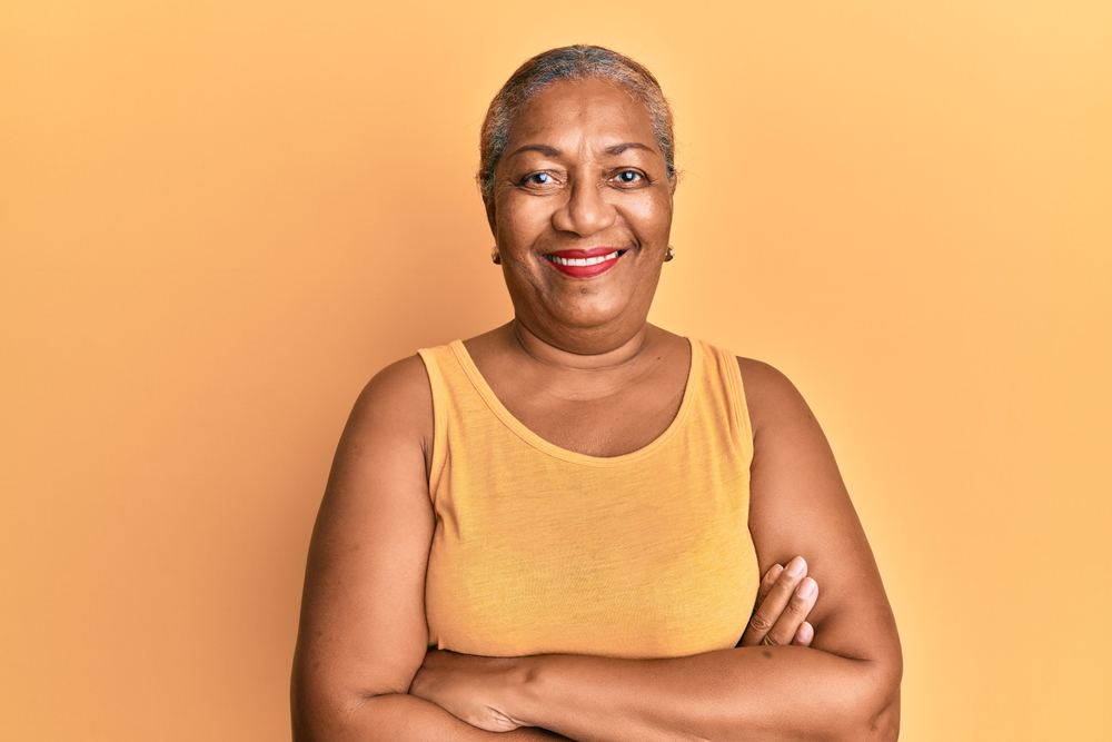 Happy senior Black woman in yellow sleeveless tank top