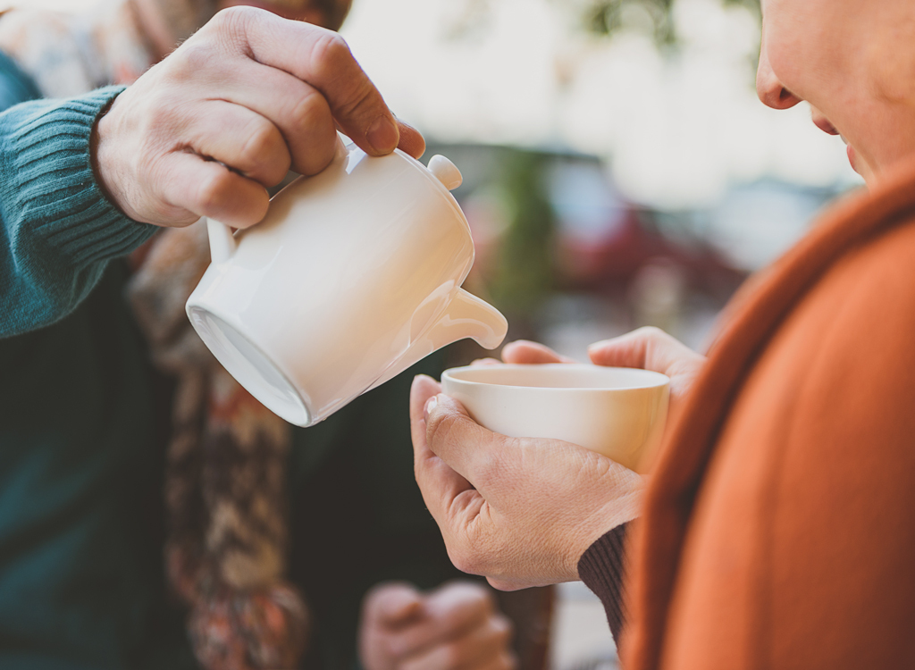 Couple pouring cup tea