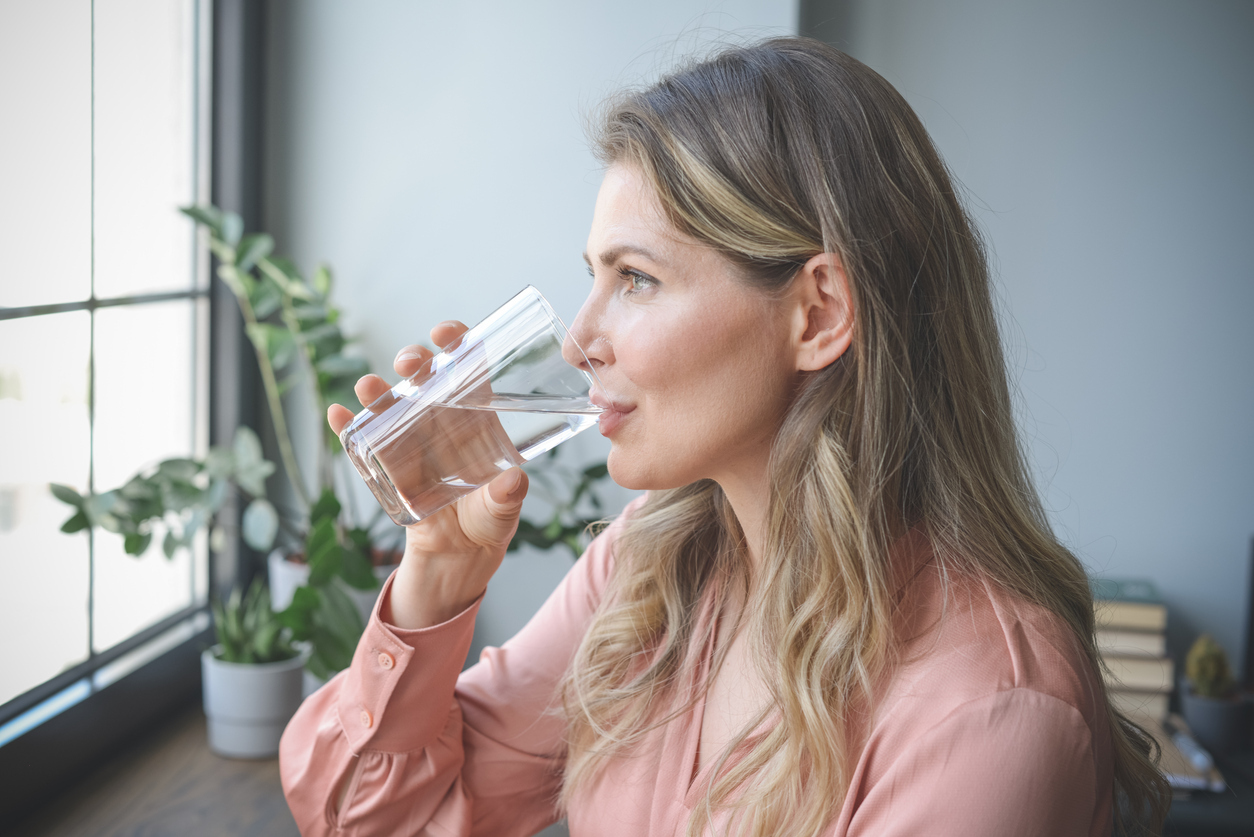 Woman drinking glass of water.