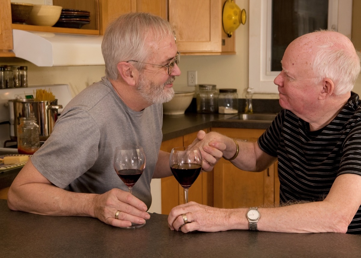 Gay couple having a serious conversation over wine